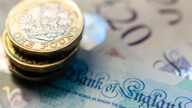 Bank Of England note with coins